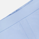 Close-up of the GREYSON Ojai Trouser Short in light blue, showcasing an elastic waistband, visible seam, and pocket on smooth cotton-blend fabric.
