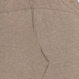 Greyson Ojai Wide Leg Pant in tan, featuring a wide-leg fit, brown drawstring, elastic waistband, and a small embroidered logo on the back.