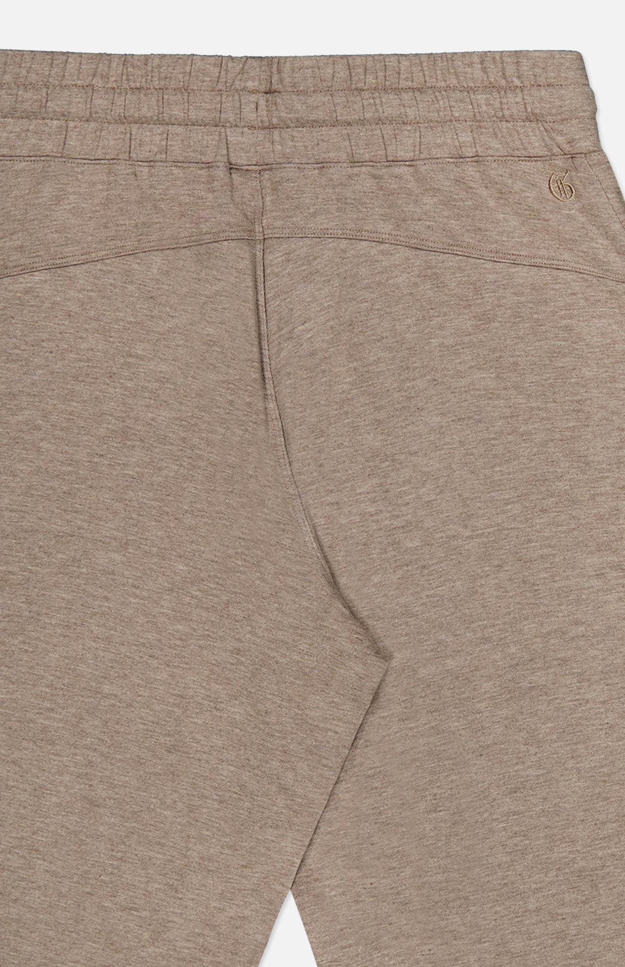 Greyson Ojai Wide Leg Pant in tan, featuring a wide-leg fit, brown drawstring, elastic waistband, and a small embroidered logo on the back.