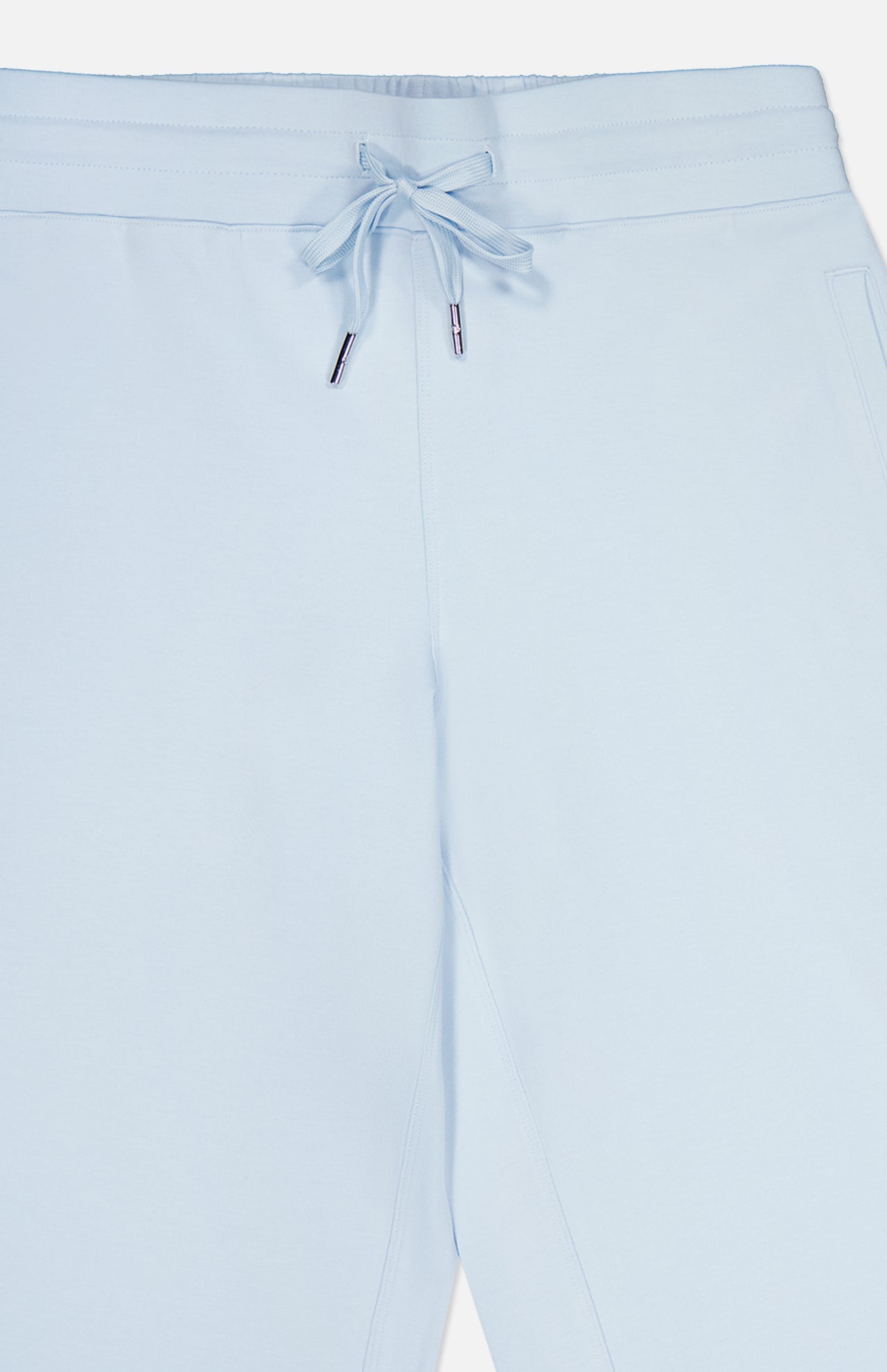 GREYSON Ojai Wide Leg Pant in light blue features a cotton-blend fabric, elastic waistband with drawstring tie, and side pockets. The image highlights the upper portion of the pants, focusing on the waistband and tie detail.