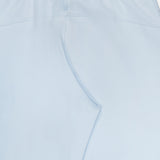 The Ojai Wide Leg Pant by GREYSON is shown here in light blue from the back, featuring an elastic waistband and subtle stitching details. Crafted from a soft and stretchy cotton-blend fabric, these pants offer a jogger-inspired look with a relaxed fit for optimal comfort.