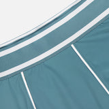 Close-up of the GREYSON Phoenix Flare Mini Skirt in teal-blue, featuring white piping and a wide striped elastic waistband. Its smooth, sporty fabric is ideal for layering over quick-drying boy shorts.
