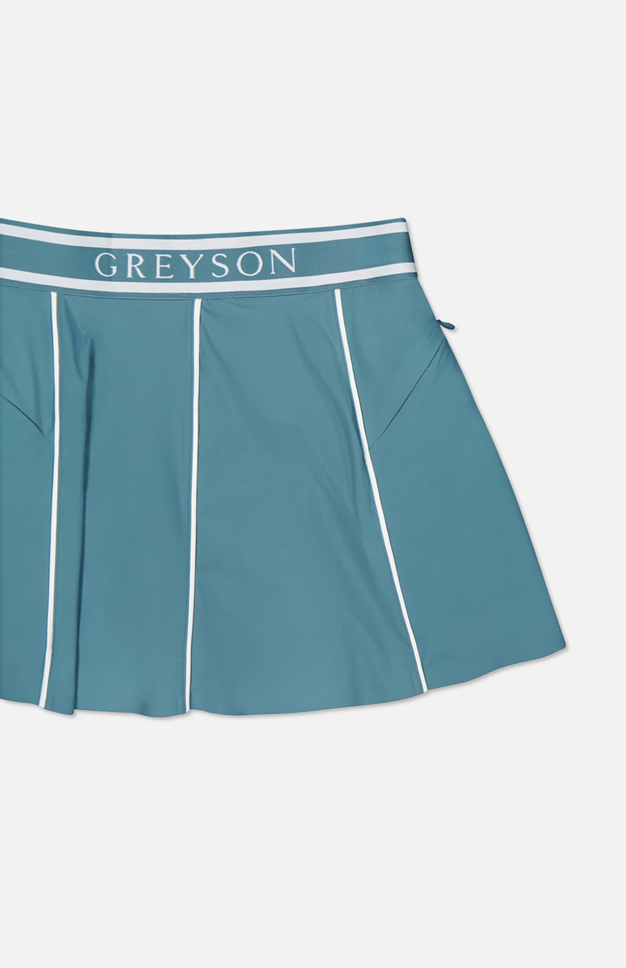 The GREYSON Phoenix Flare Mini Skirt is a teal athletic mini skirt with white piping, a bold GREYSON waistband, and quick-drying boy short lining for comfort.