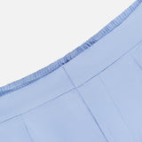 Close-up of the waistband and upper section of the light blue Phoenix Wide Leg Trouser Pant by GREYSON, featuring an elastic back and visible stitching details on a white background.