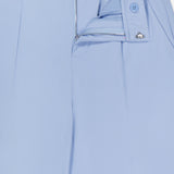 The GREYSON Phoenix Wide Leg Trouser Pant in light blue features a partially open zipper, visible button and hook closure, elastic waistband section, front pleats, and a clean, tailored design for a modern look.