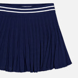 GREYSON Pointelle Mini Skirt in navy blue, featuring quick-dry fabric, a textured pattern, and a navy waistband accented with two parallel white stripes at the top. The skirt is shown laid flat on a white background.