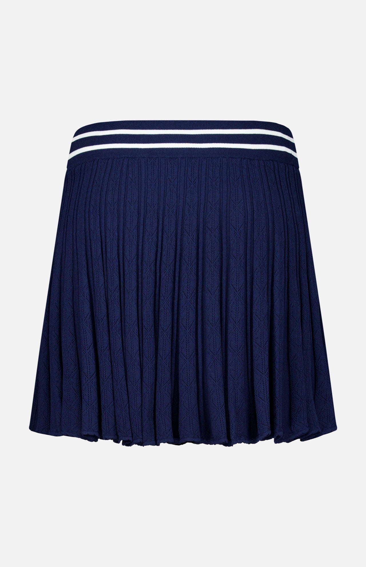 Crafted by GREYSON, the Pointelle Mini Skirt is a navy blue piece with a ribbed texture and pleated design. It features a waistband accented by two white stripes near the top and comes with a built-in undershort for enhanced comfort and coverage.