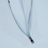 Close-up of a silver zipper partially unzipped on the GREYSON Soleil 1/2 Zip Pullover Sweater in light blue, revealing an Italian double-faced white and blue pinstriped fabric underneath.