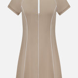 Greyson Soleil Mini Polo Dress in beige, featuring a white collar, quarter-zip neckline, and white piping details along the seams.
