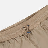 Beige Wide Nylon Pant with Drawcords featuring an elasticized waistband and a metal-tipped drawstring.