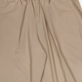 Greyson Wide Nylon Pant in tan, featuring a wide-leg stretch nylon design with an elasticated waistband and drawstring closure.