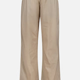 Greyson Wide Nylon Pant in beige, featuring a wide-leg athletic fit with an elastic waist, front drawstring, and adjustable toggles at the hems.