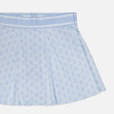 The Wolf Links Phoenix Flare Mini Skirt by GREYSON features a light blue hue with pleats, a subtle repeating geometric pattern, and a wide waistband. Built-in shorts provide added comfort, all showcased against a white background.