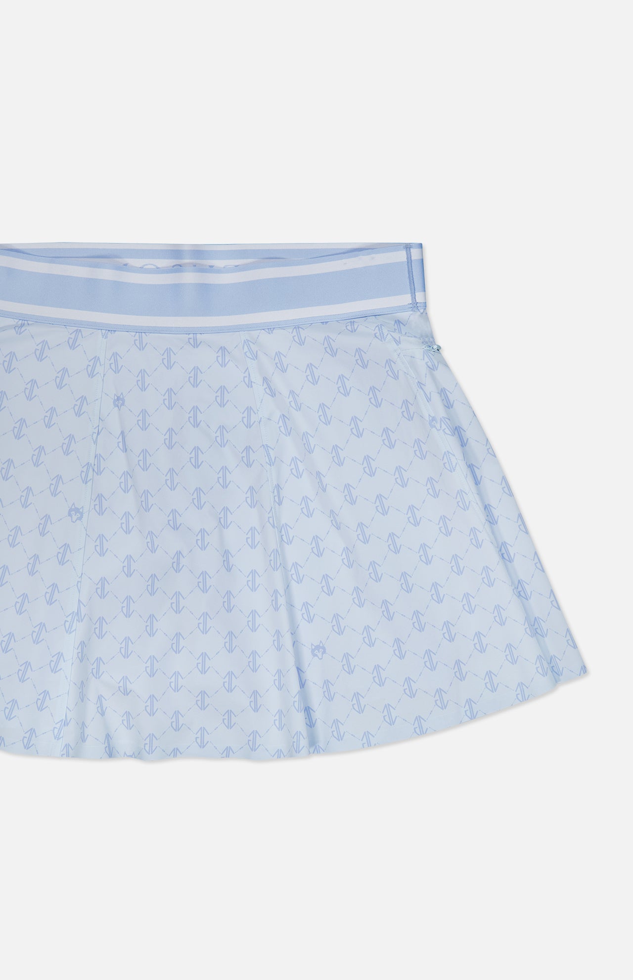 The Wolf Links Phoenix Flare Mini Skirt by GREYSON features a light blue hue with pleats, a subtle repeating geometric pattern, and a wide waistband. Built-in shorts provide added comfort, all showcased against a white background.