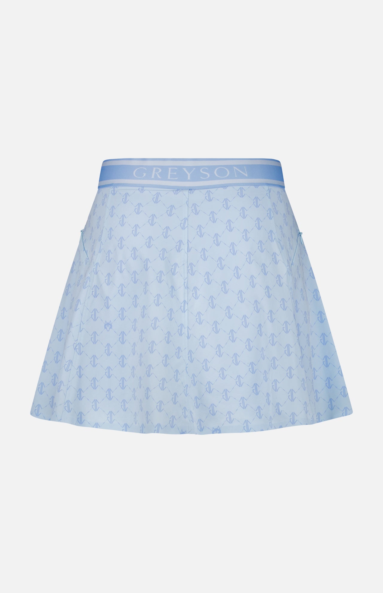 The Wolf Links Phoenix Flare Mini Skirt by GREYSON is a light blue mini skirt showcasing a subtle repeating wolf links monogram pattern. It features built-in shorts for added comfort, a wide waistband with GREYSON branding, and two side pockets, displayed on a plain white background.