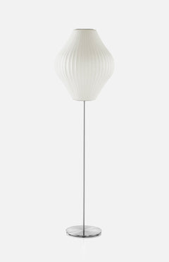 The HERMAN MILLER Nelson Pear Lotus Floor Lamp features a brushed nickel stand, a white, ribbed, rounded lampshade, and a circular base—all set against a plain white background.