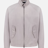 The HERNO Dean Cotton Bomber Zip Jacket is a men's light grey, minimalist spring outerwear featuring long sleeves, high collar, front zipper closure, and two angled pockets in a clean, unbranded bomber jacket style.