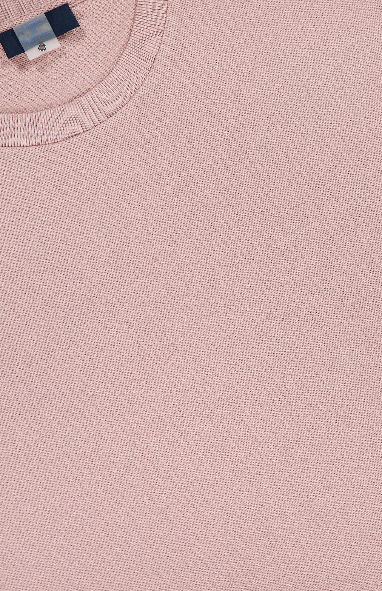 Close-up of the HERNO Jersey Knit Short Sleeve Crewneck T-Shirt in light pink, laid flat to show the ribbed collar and a peek at the neck tag. The cotton fabric looks soft and smooth.