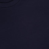 Close-up of the HERNO Jersey Knit Short Sleeve Crewneck T-shirt in dark navy, made from ultra-soft 100% cotton with a ribbed crewneck and a small tag near the neckline.
