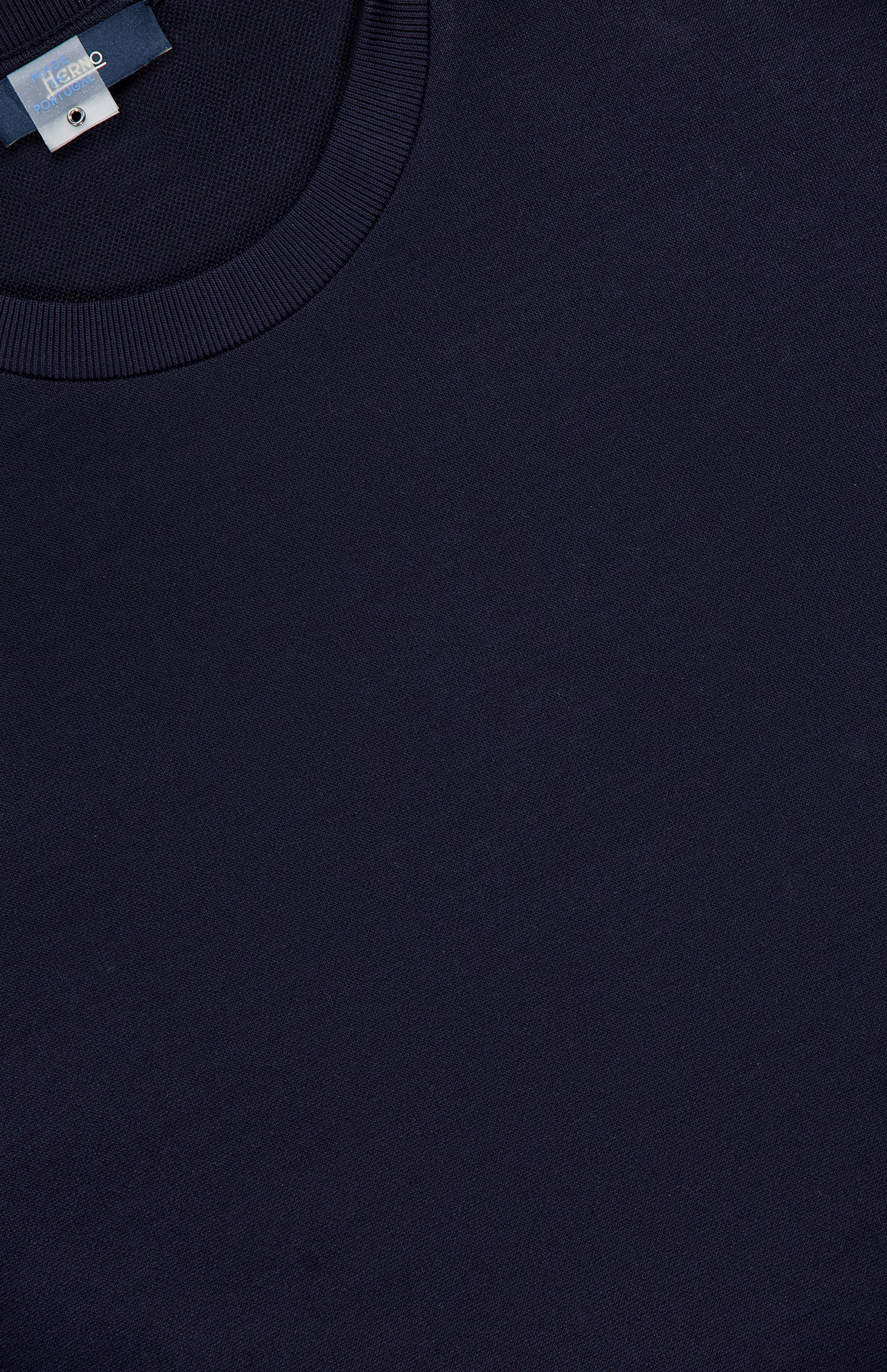 Close-up of the HERNO Jersey Knit Short Sleeve Crewneck T-shirt in dark navy, made from ultra-soft 100% cotton with a ribbed crewneck and a small tag near the neckline.