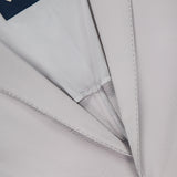Close-up of the HERNO Seersucker 2 Button Blazer for men, shown in light grey textured fabric with visible button, lapel, and navy blue interior HERNO label.