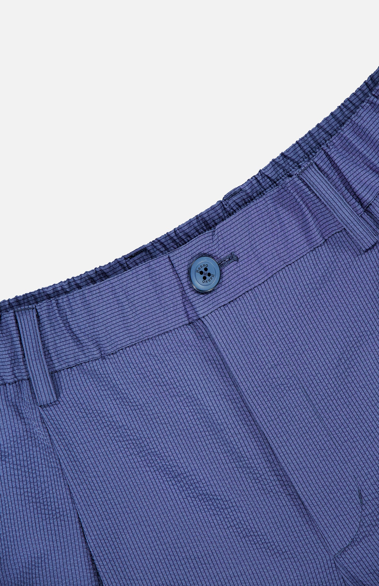 Close-up of the HERNO Seersucker Trouser Pant in blue with subtle pinstripes, showcasing an elastic waistband, belt loops, blue button, and zipper fly—ideal for comfortable spring-summer style.