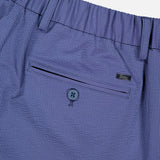 Close-up of HERNO Seersucker Trouser Pant, featuring a blue seersucker fabric, elasticized waistband, belt loops, buttoned back pocket, and a small Legno label—ideal for comfortable spring and summer wear.
