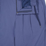 Close-up of HERNO Seersucker Trouser Pant in blue, featuring an elasticized waistband, drawstring, button closure, and zipper fly. Partially open to reveal inner lining and pocket—an ideal choice for spring and summer.