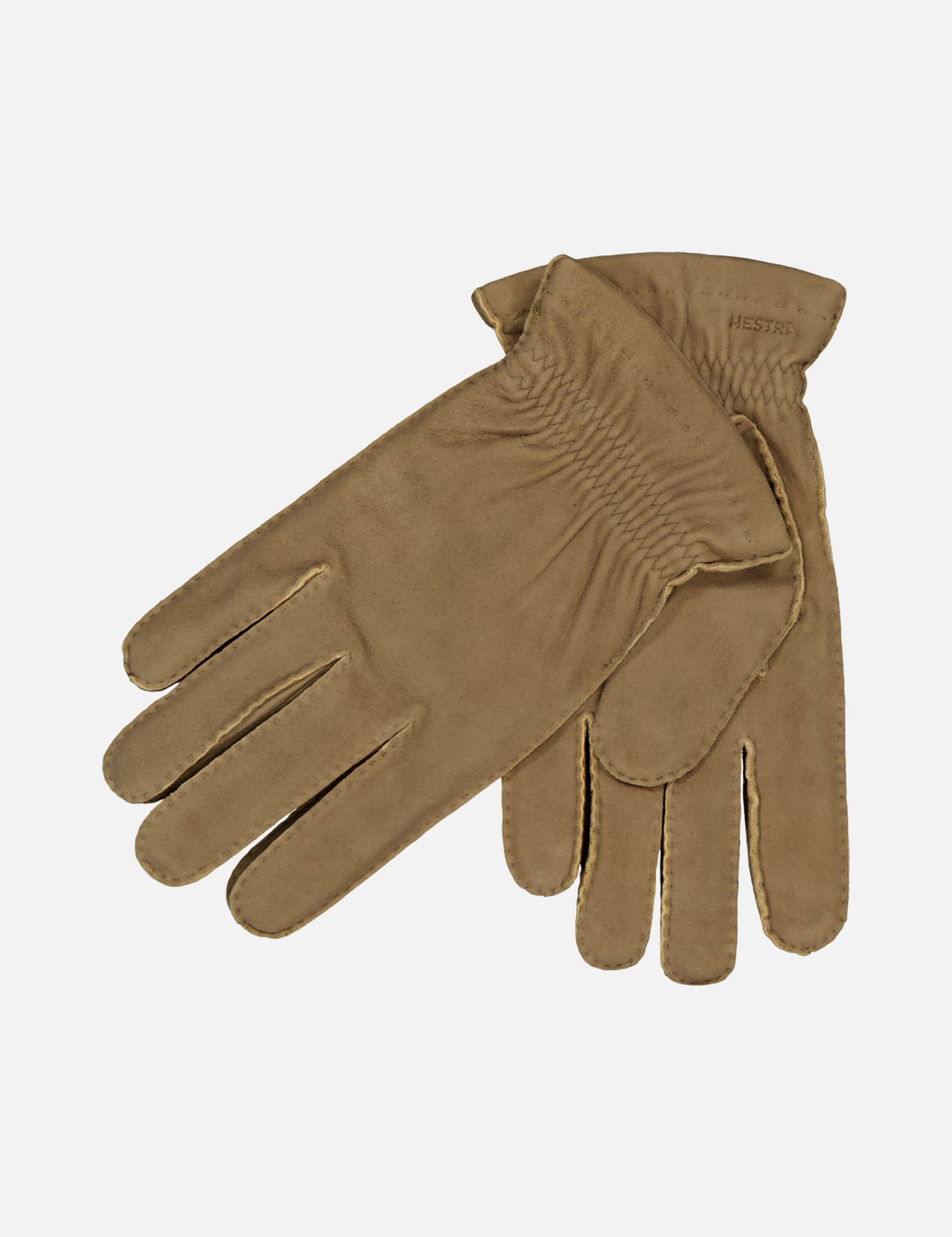 The HESTRA Andre Leather Gloves in light brown chamois leather are shown laid flat on a white background, with one glove overlapping the other and soft wool lining visible at the cuff.