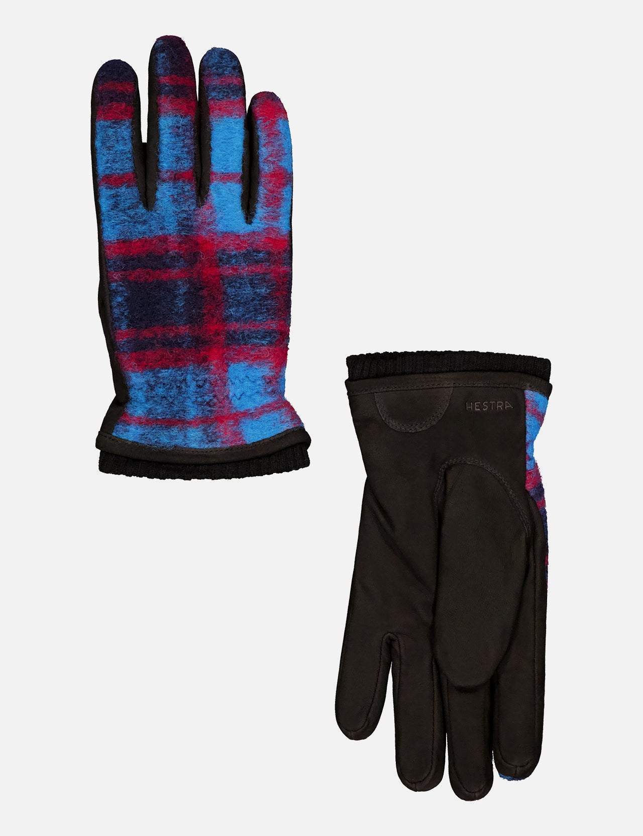 The HESTRA Noah Glove is a men's everyday pair featuring black suede on the palm and a blue, red, and black plaid wool jersey pattern on the back, finished with black trim and visible HESTRA branding.