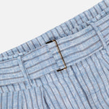Close-up of the HEVRON Alina Wide Leg Linen Pant’s light blue and white striped fabric waistband with metal buckle, shown on a plain white background.