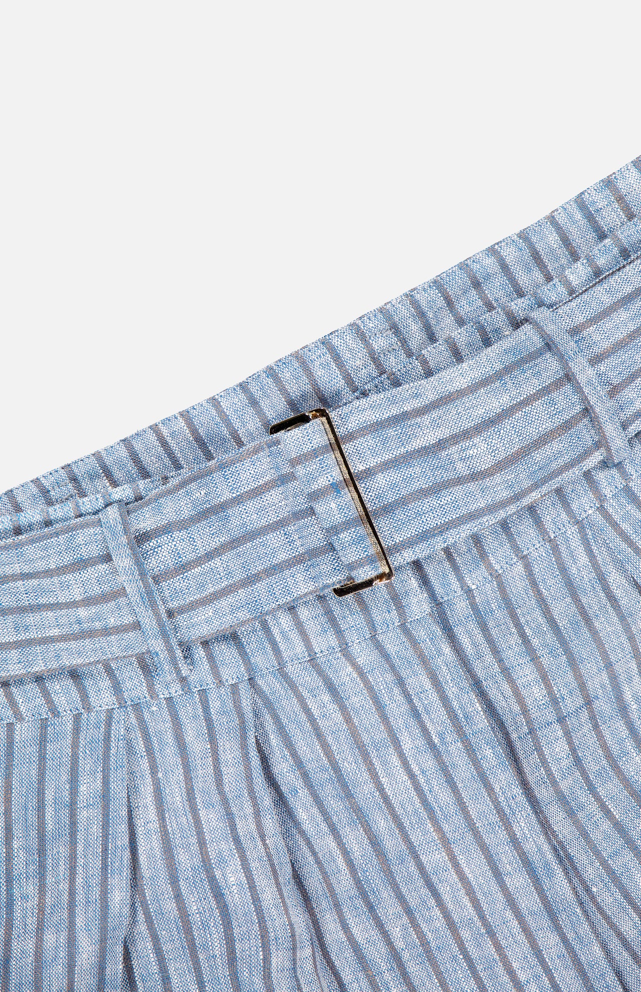 Close-up of the HEVRON Alina Wide Leg Linen Pant’s light blue and white striped fabric waistband with metal buckle, shown on a plain white background.