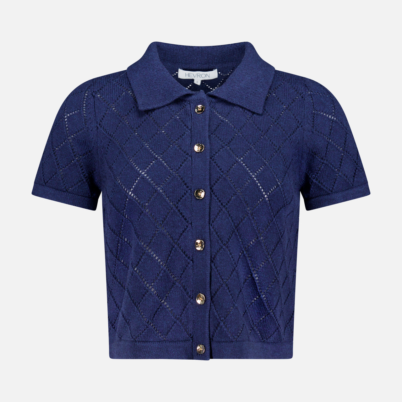 The Arlet Diamond Pointelle Top by HEVRON features short sleeves, a classic collar, gold front buttons, and a navy diamond pointelle knit, shown against a plain white background.