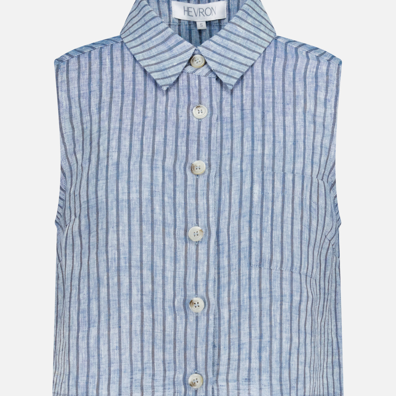The Katja Cropped Linen Top by HEVRON is a sleeveless blue and white vertically striped top with a collar, six front buttons, and a visible HEVRON brand tag inside the neckline.