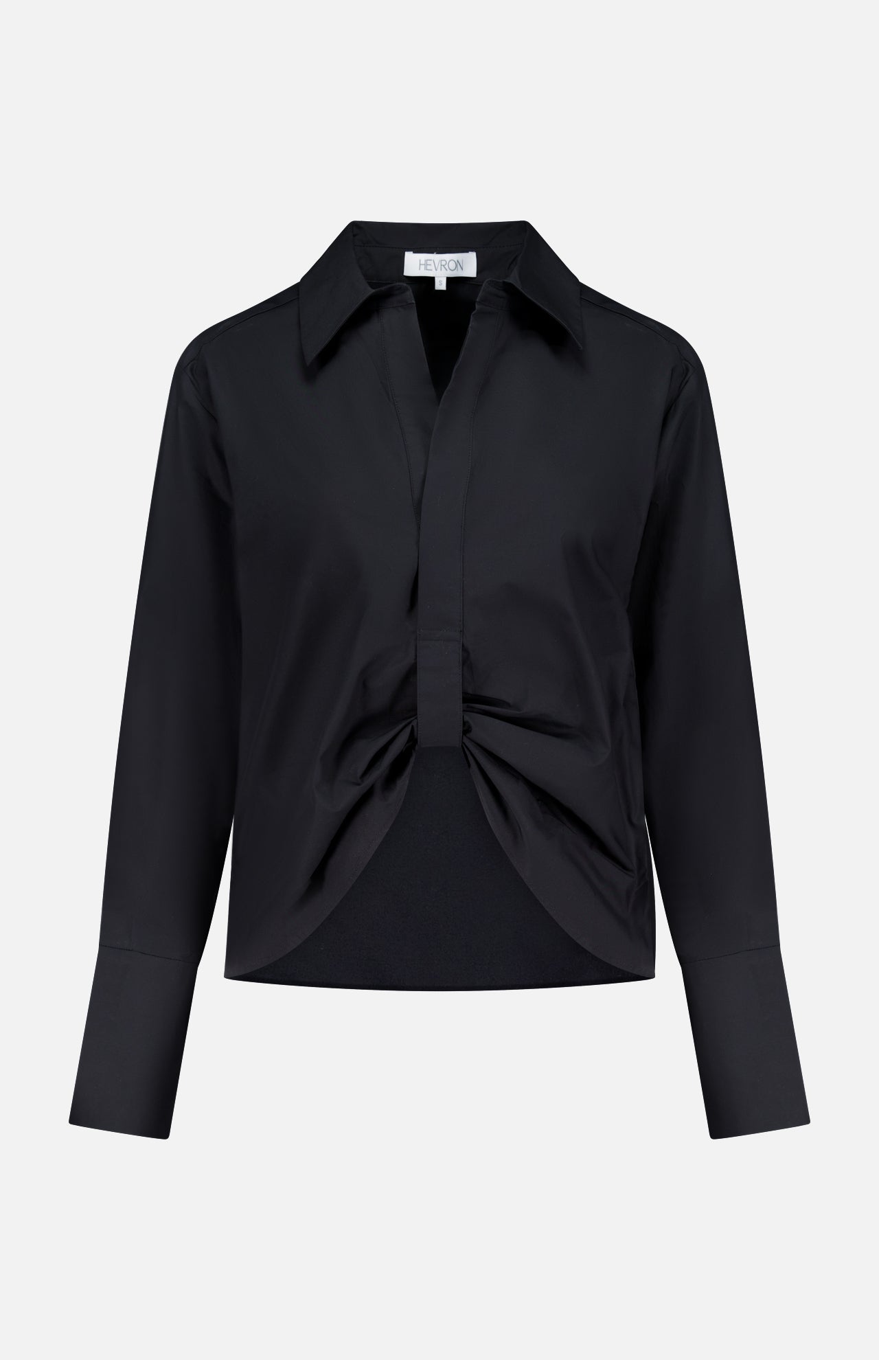 The Paola Adjustable Front Top by HEVRON is a black, long-sleeve collared blouse featuring a front knot detail and wide cuffs, shown against a plain white background.