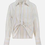 The HEVRON Paola Front Tuck Top showcases white vertical stripes on beige, a collared neckline, adjustable front epaulette, twist detail, and buttoned cuffs. Displayed against a plain white background.