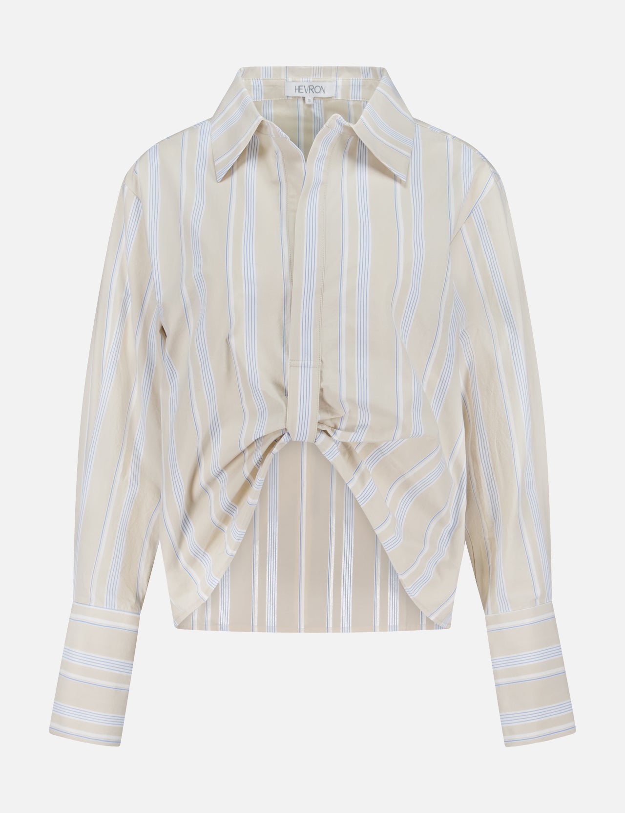The HEVRON Paola Front Tuck Top showcases white vertical stripes on beige, a collared neckline, adjustable front epaulette, twist detail, and buttoned cuffs. Displayed against a plain white background.