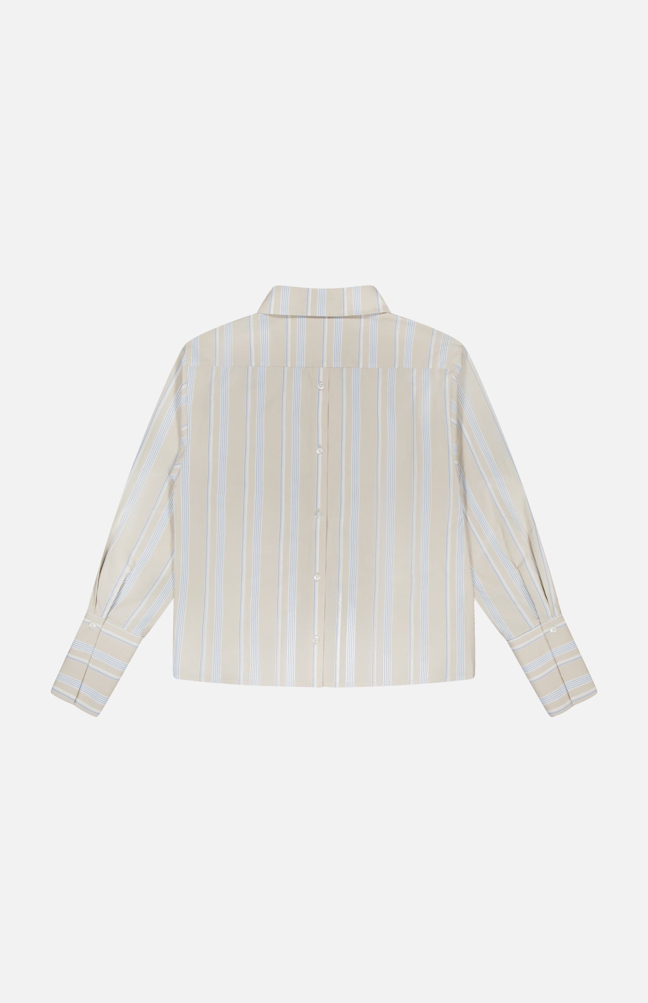 The HEVRON Paola Front Tuck Top is shown from the back in beige with vertical white and blue stripes. It features a classic collar, back button detail, and long sleeves for a refined look.