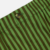 Close-up of the Remi Stripe Shorts by HEVRON, featuring green and dark green vertical stripes, a button, and an elastic waistband—perfect for a summer set.
