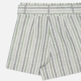 Close-up of HEVRON's Zinna Striped Linen Short with vertical green, grey, and white stripes. The lightweight fabric and matching waistband make these shorts ideal for a relaxed, stylish summer look.