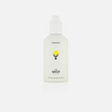 A white bottle labeled HIGHLAND STYLE CO. with a black stag head logo and “The Wash Hair Care.” This pH-balanced cleanser features a pump dispenser, suitable for hair and body, and stands against a plain white background.