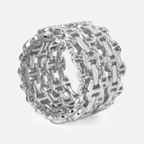 Showcased against a plain white background, the Damash Multi-Stacked Ring by HOORSENBUHS features a bold, chunky sterling silver design with an interlocking tri-link motif—a striking unisex chain-link statement piece.