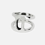 The Dame Phantom II Ring by HOORSENBUHS is a striking example of modern unisex jewelry, crafted in shiny sterling silver with a bold, open geometric design featuring a large oval-shaped cutout at the center and subtle tri-link motif accents. The ring is showcased against a plain white background.