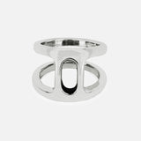 The Dame Phantom II Ring by HOORSENBUHS features two parallel sterling silver bands connected by a vertical bar and an oval cutout at the center, showcasing a subtle tri-link motif. Displayed on a plain white background, this distinctive piece is an ideal choice for unisex jewelry lovers.
