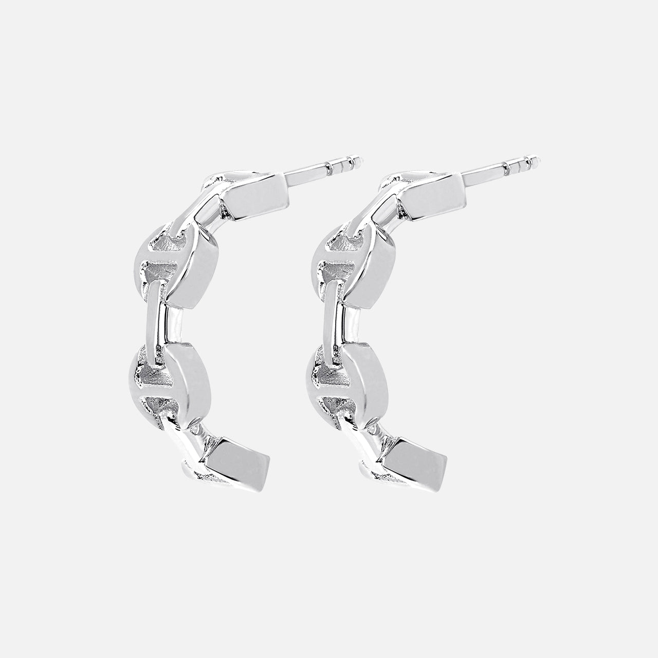 The HOORSENBUHS Micro Crescent Earrings feature interlocking tri-link chain motifs in silver, displayed on a light gray background—an elegant unisex jewelry choice.