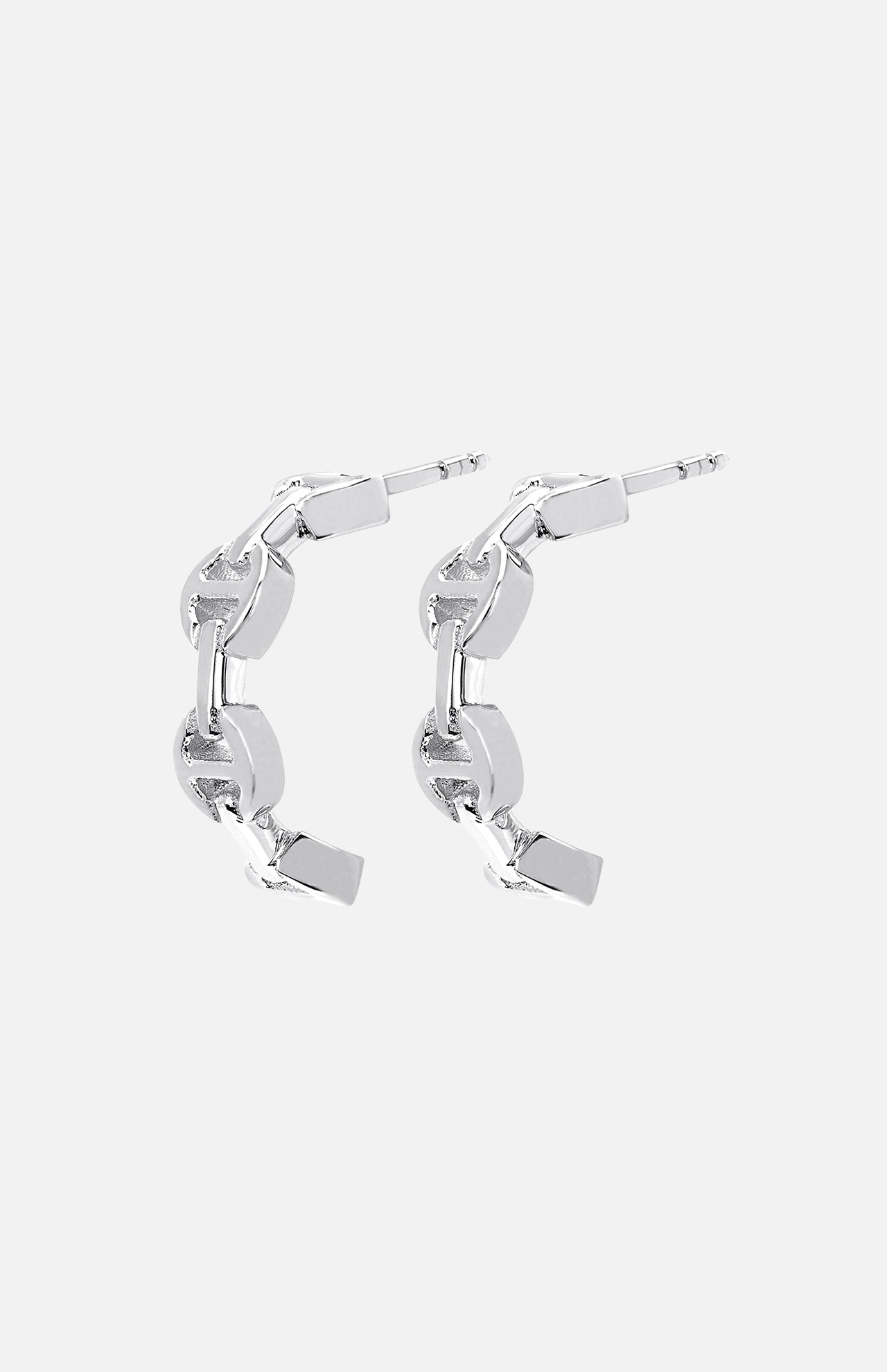 The HOORSENBUHS Micro Crescent Earrings feature interlocking tri-link chain motifs in silver, displayed on a light gray background—an elegant unisex jewelry choice.