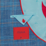 Close-up of the ISAIA Check Light Summer Hopsack Sportcoat, a men's blue plaid blazer with red-edged light blue lining, triangular flap with red button, and signature coral logo label—highlighting refined Italian craftsmanship.