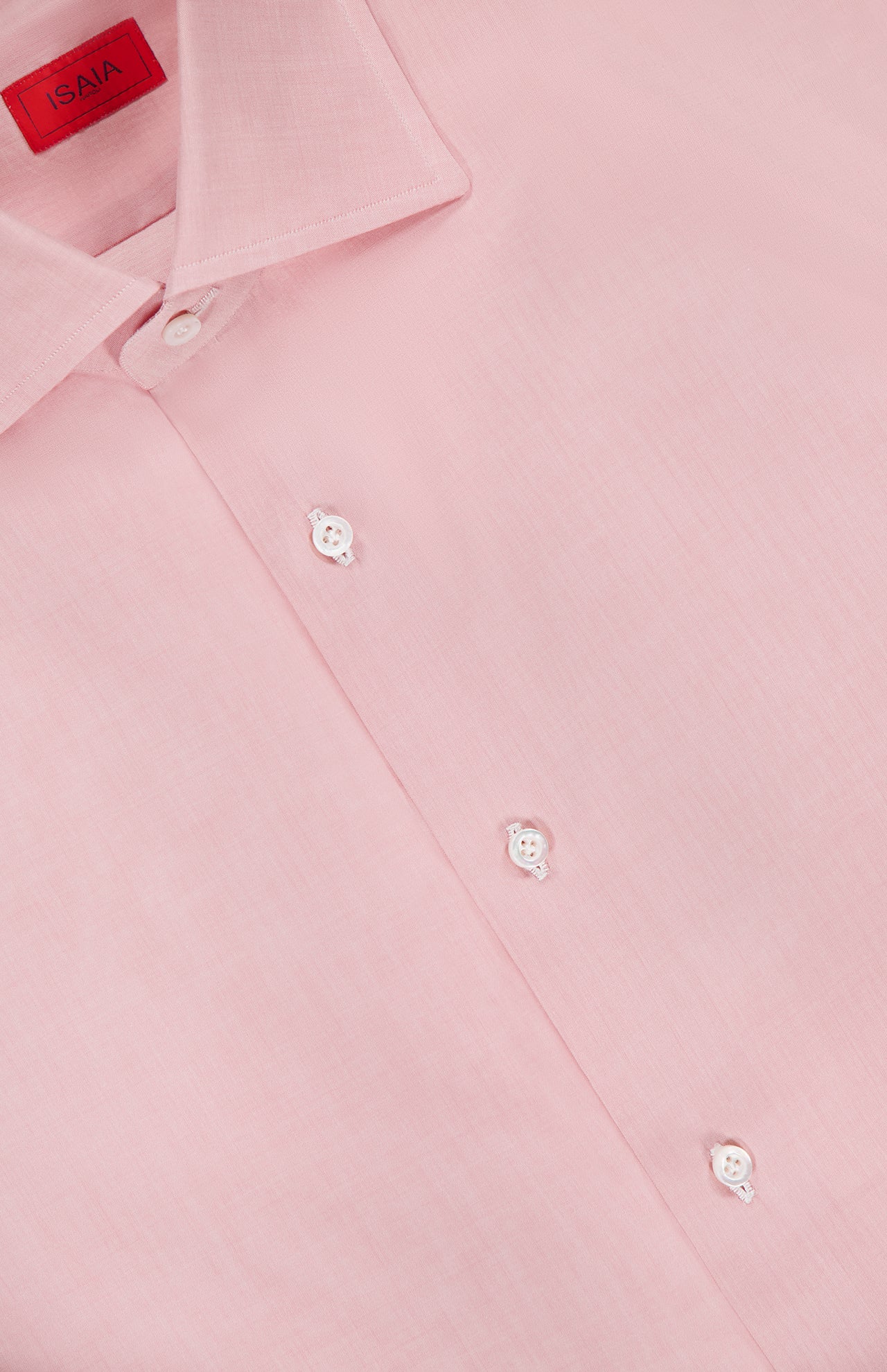 A close-up of the ISAIA Egyptian Cotton Dress Shirt in light pink, featuring white buttons and a visible red label inside the collar.