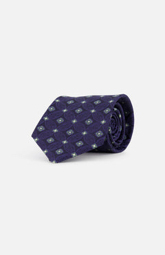 The ISAIA Fantasia Cravatte Decorative Silk Tie features a rolled-up purple design with a light blue and white geometric pattern, displayed on a plain white background.