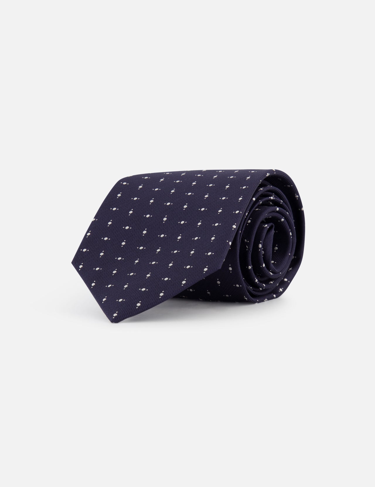 The ISAIA Fantasia Cravatte Micro Print Silk Tie in navy features a subtle white dotted pattern, presented neatly rolled on a plain white background.